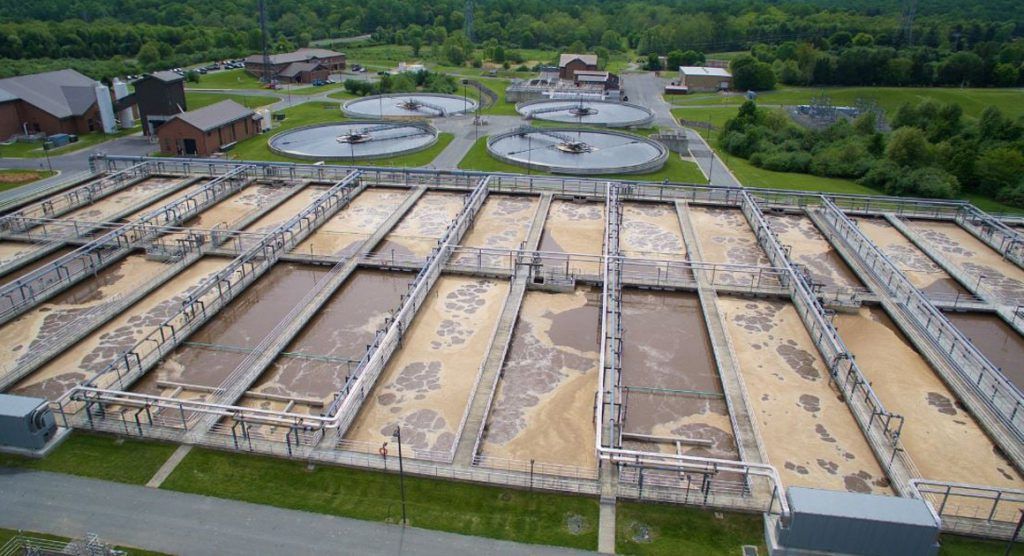 View from above of vast vats of brown liquid.