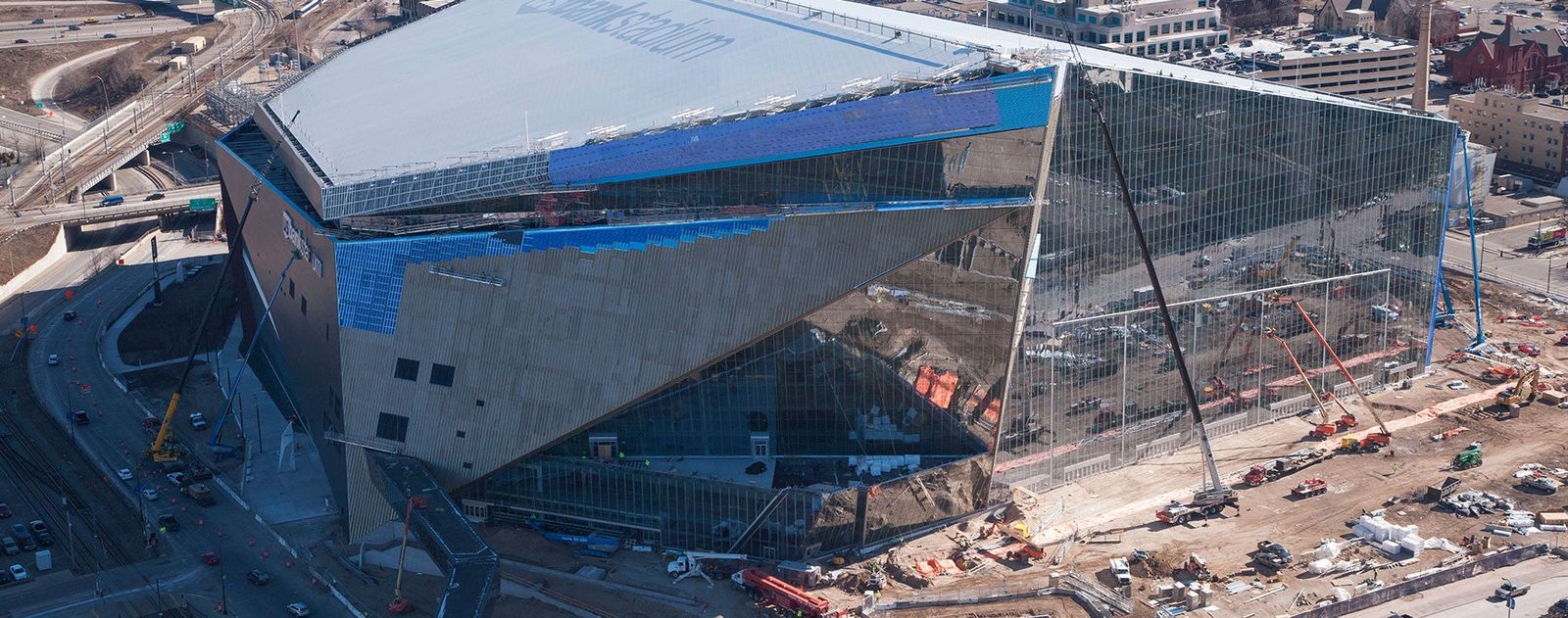 Construction work on the large glass exterior of U.S. Bank Stadium